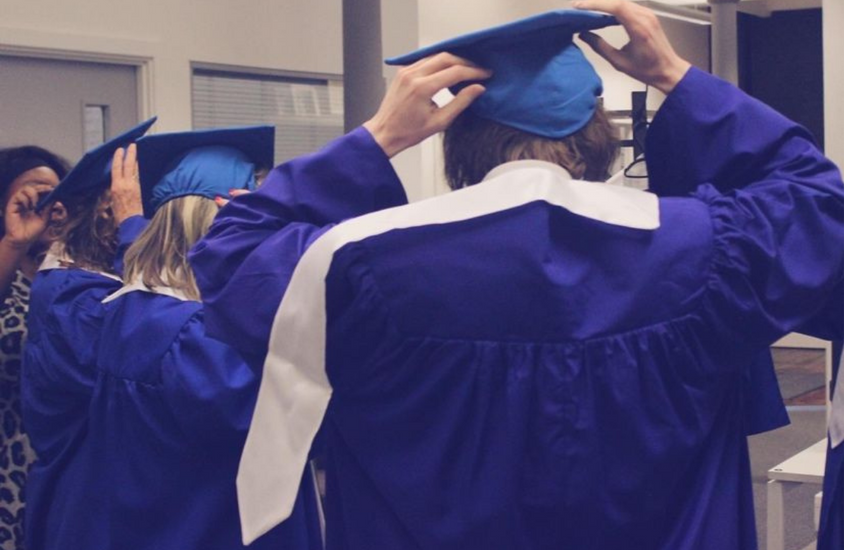 Grads_Putting_on_Cap_and_Gowns